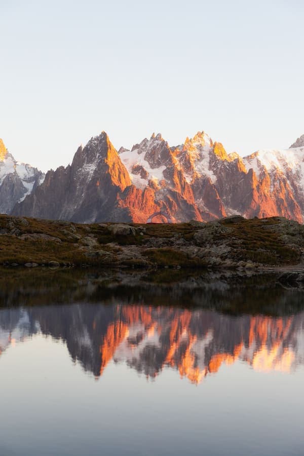 Mountain tarns facing a dusk-lit massif